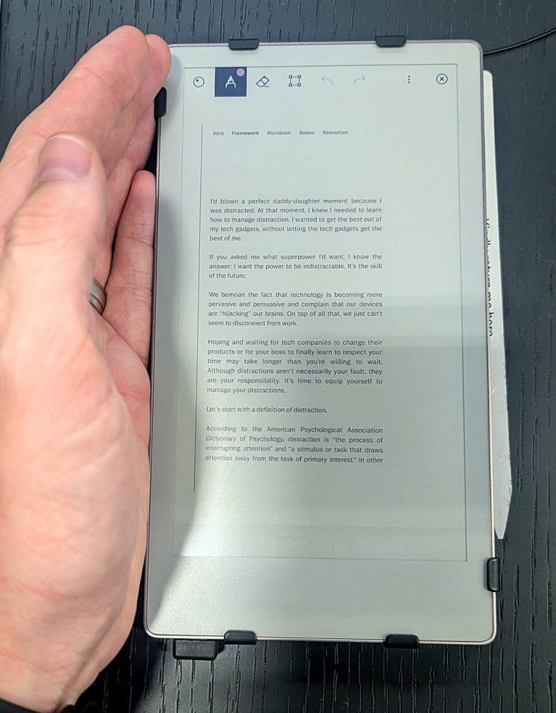 Holding the reMarkable Paper Pro Move 7.3-inch e-ink tablet to show its size